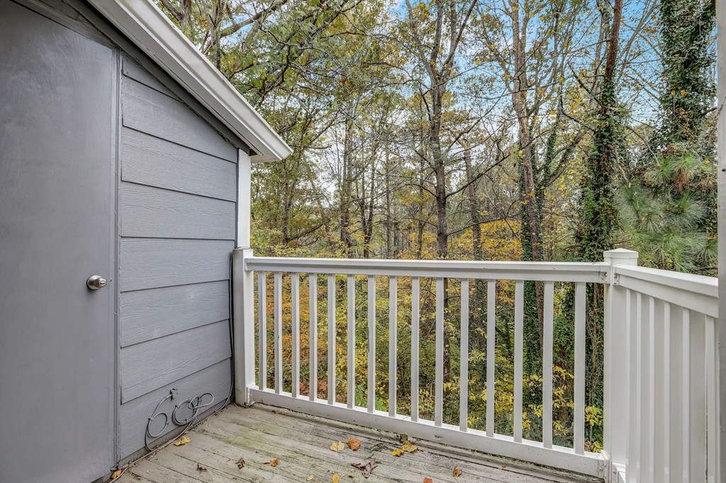 a backyard deck with a garage door and trees