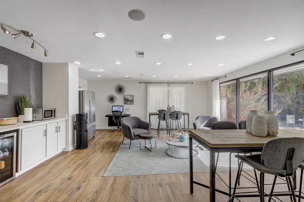 a living room and dining room with a table and chairs