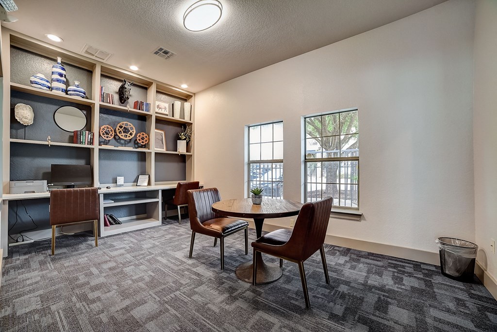 a room with a table and chairs and a bookshelf