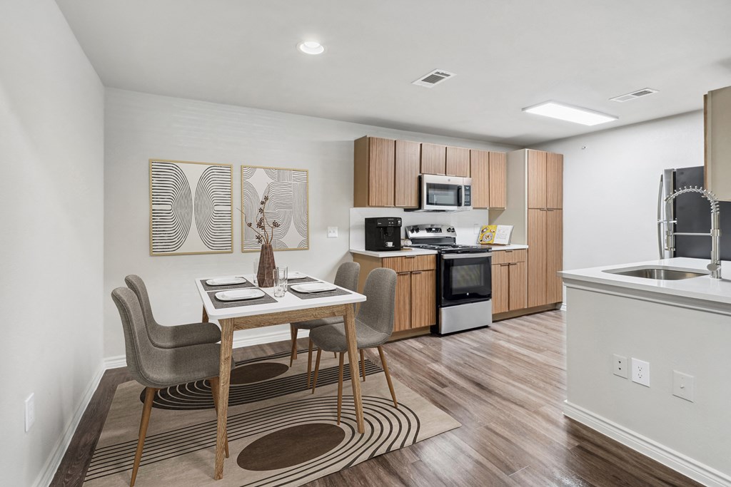 a kitchen and dining room with a table and chairs