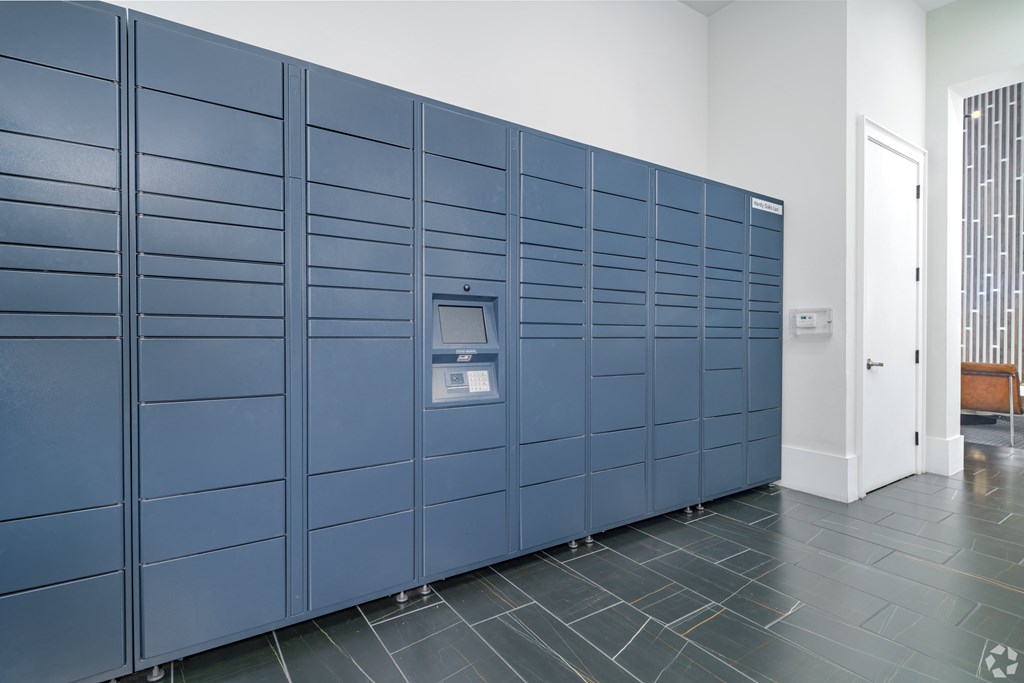 A row of blue lockers in a room.