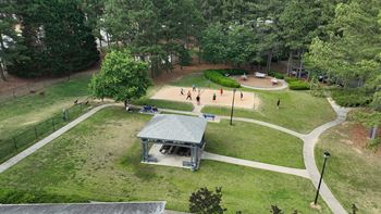 a park with a playground and a pavilion      and trees