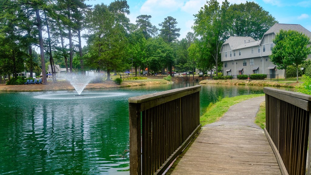 A view of the lake with a fountain and our apartment homes in the background