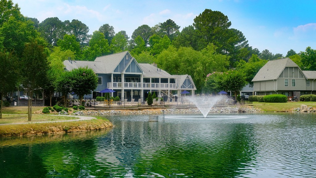 Amberlake Village's property Exterior Surrounded by Lush Greenery and a Beautiful Lake