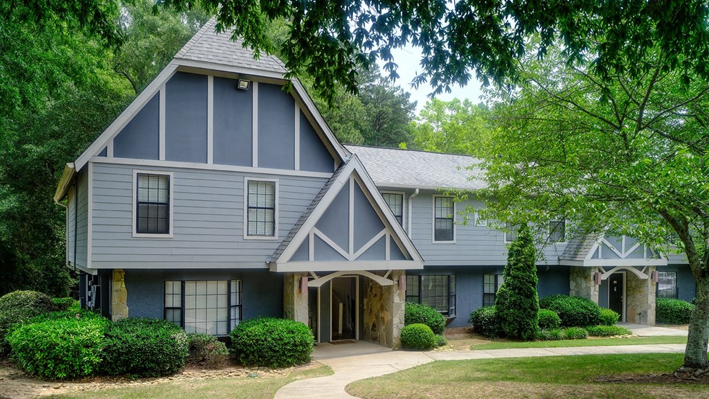 The front of one of the homes with a blue and white paint and stone exterior