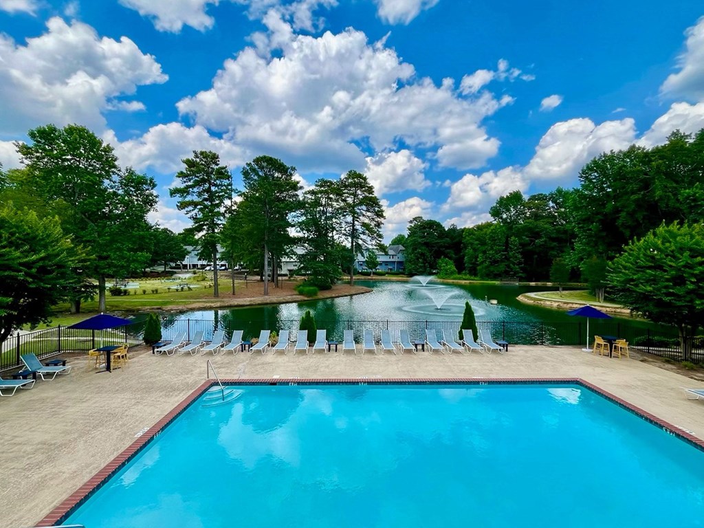 Lakeside swimming pool with lounge chairs around it