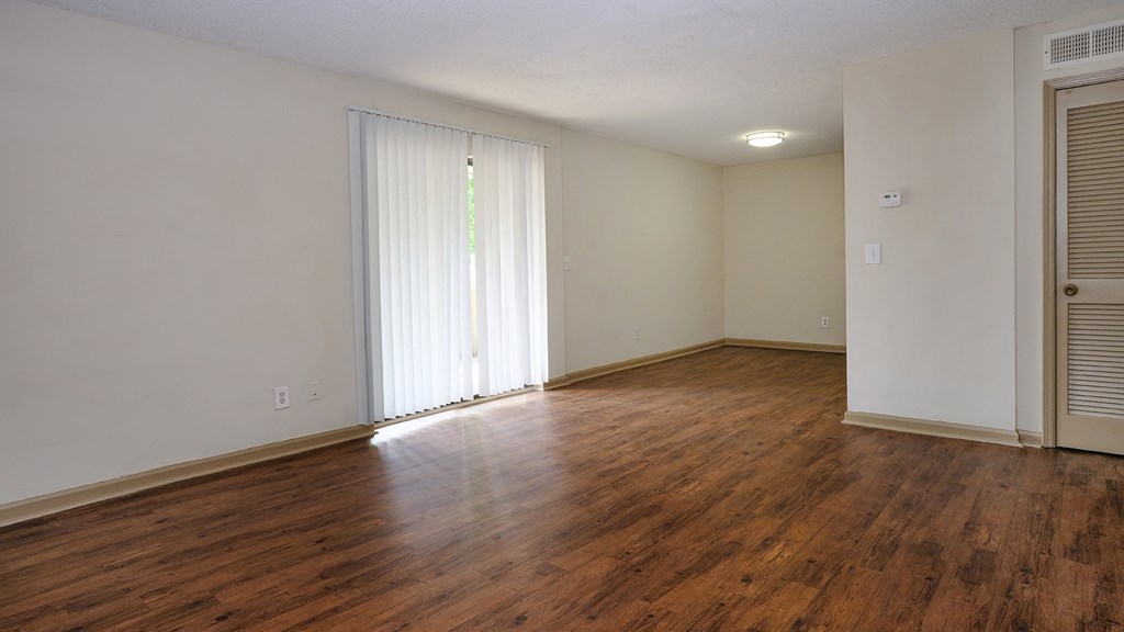 The interior of our homes with hardwood floors, white wall, and plenty of natural lights