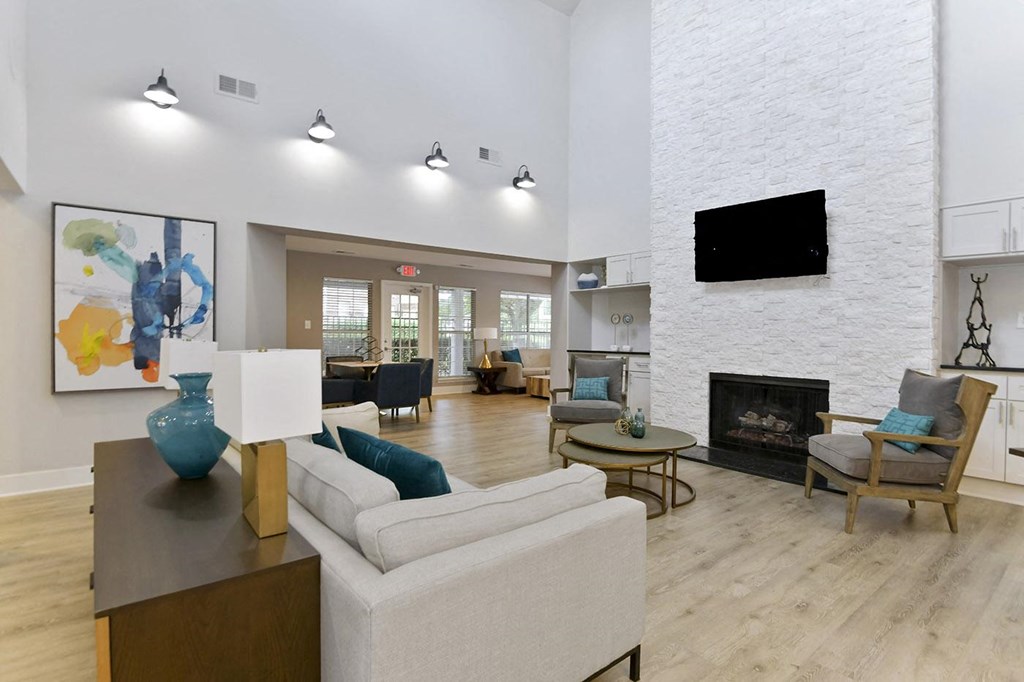 Canopy at Baybrook renovated Leasing Office with a modern couch fireplace and TV