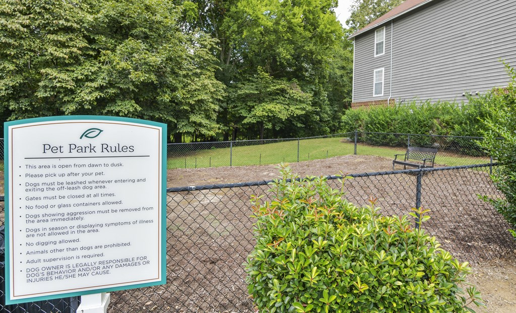 a dog park with a sign that says pet park rules at Canopy at Baybrook apartments in Charlotte NC