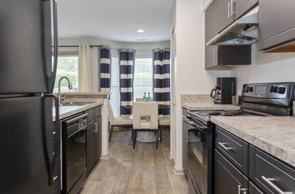 a kitchen and dining area at Canopy at Baybrook apartments in South Charlotte