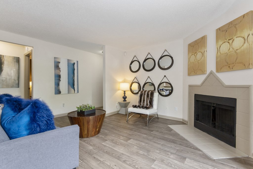 a living room with a fireplace and a couch at Canopy at Baybrook apartments in South Charlotte