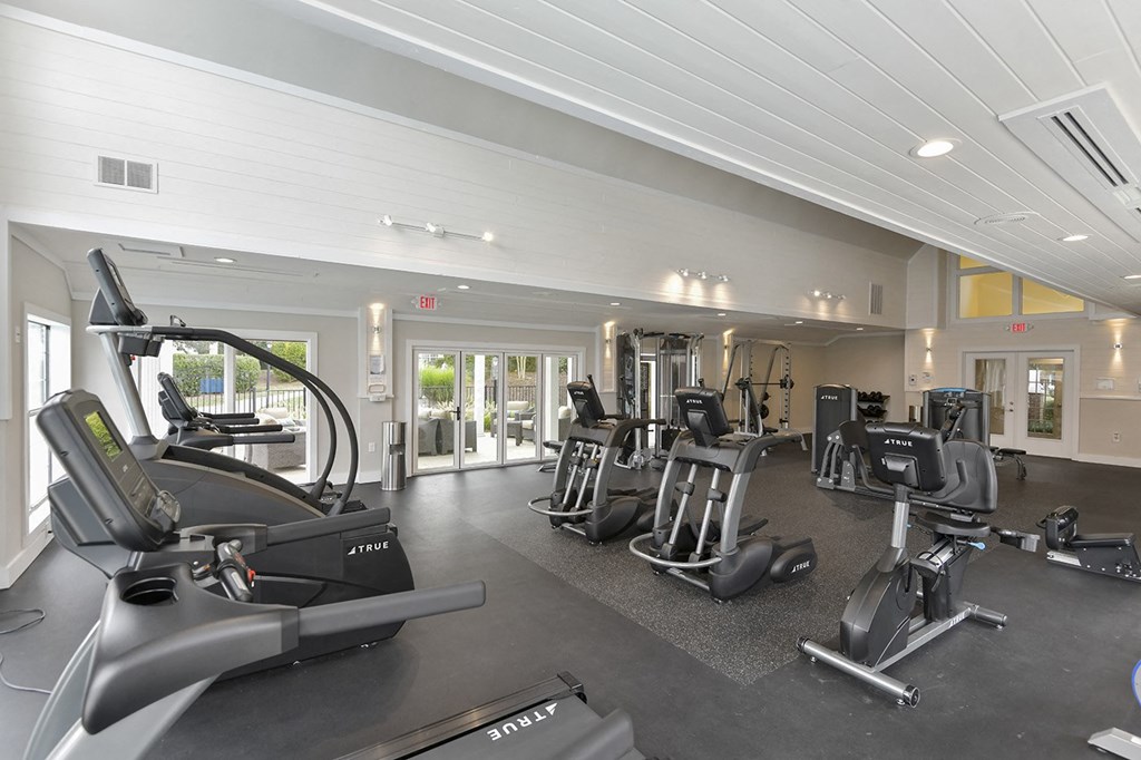 a gym with cardio machines and other exercise equipment at the estates at johnston crossing