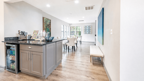A kitchen with a bar and a bench.