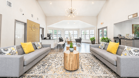 A living room with grey couches and a wooden coffee table.