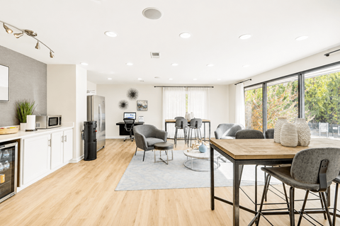 A modern kitchen with a dining table and chairs.