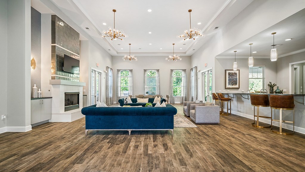 a living room with a blue couch and a fireplace