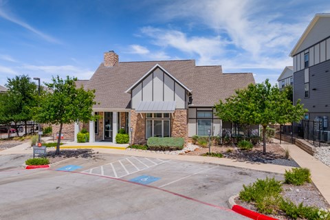 A building with a brick facade and a large front porch.