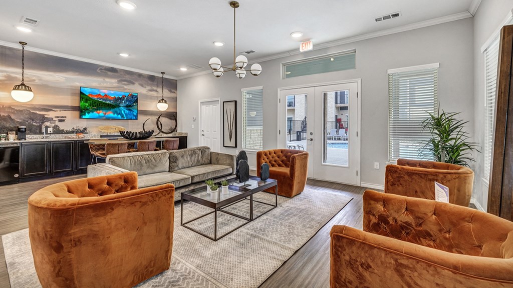a living room with couches and chairs and a table