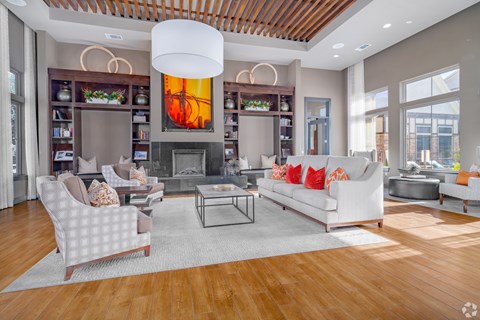 A modern living room with a fireplace and a large painting above it.