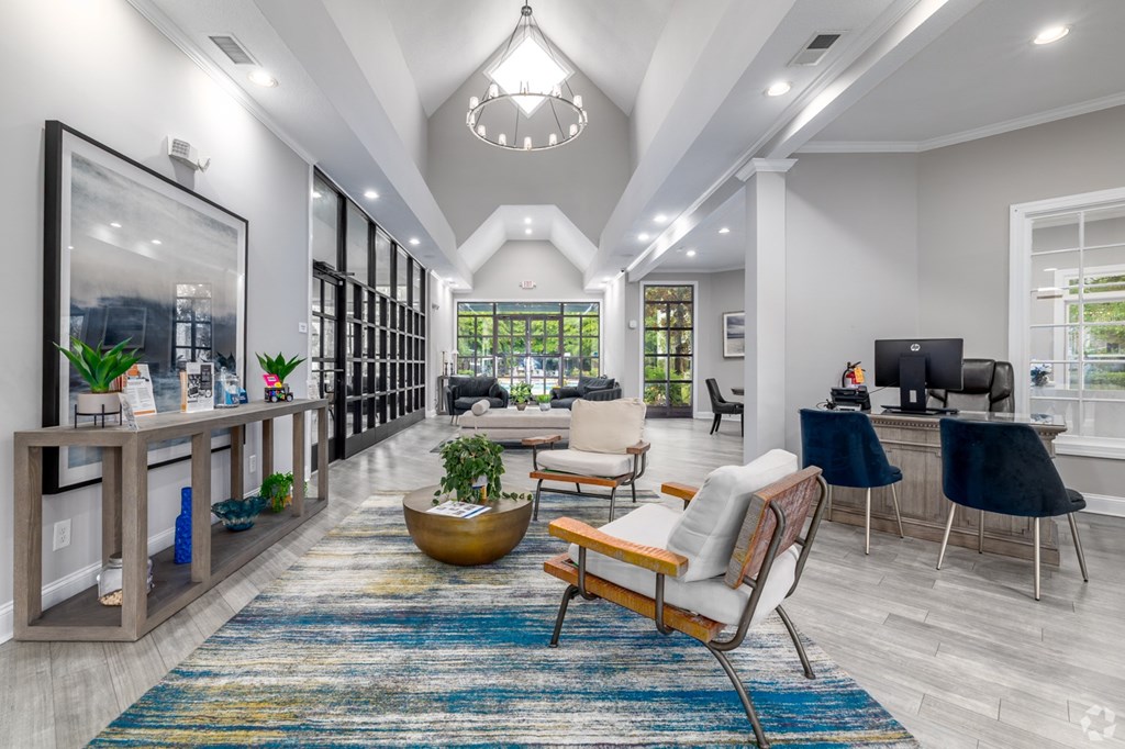 A modern living room with a large rug and a wooden chair.