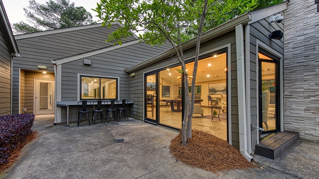 Wynnwood Vinings resident poolside lounge patio with bar and glass entrance door