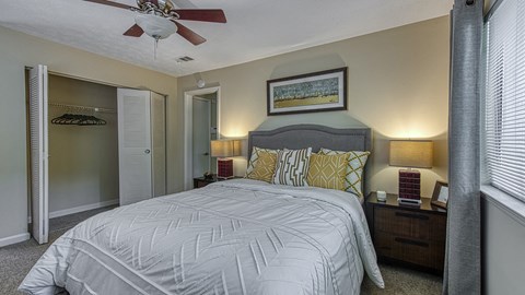 a bedroom with a large bed and a ceiling fan at Wynnwood Vinings Atlanta