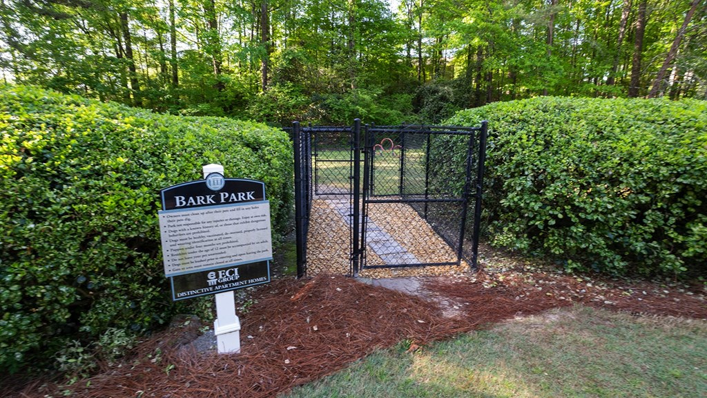 a gate to a park with a sign that says bark park at Wynnwood Vinings