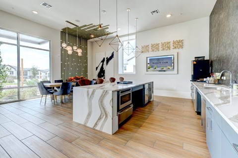 a kitchen and dining area with a table and chairs and a large window