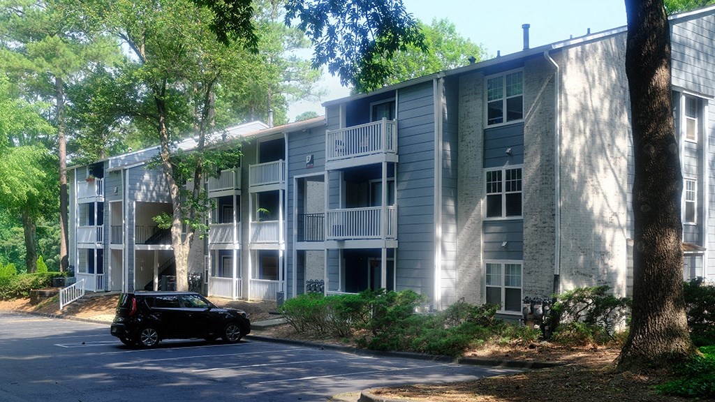 a car parked in front of an apartment building