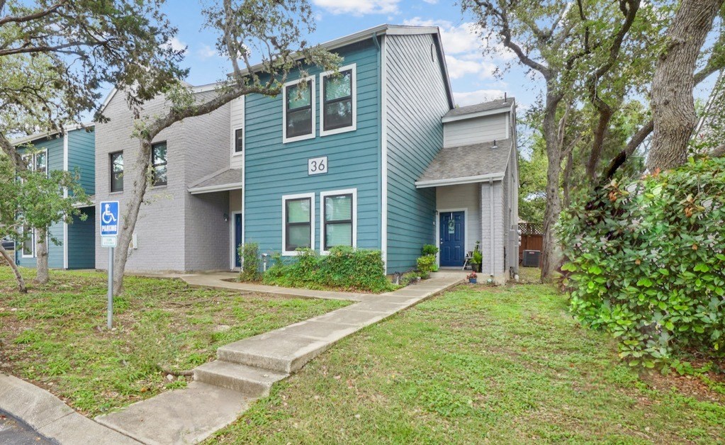a blue house with a blue door and gray and white siding
