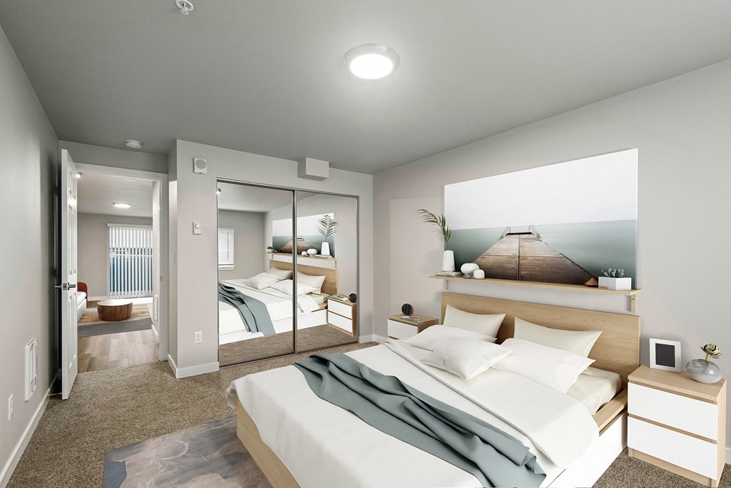 a renovated bedroom with a large bed and a mirror at  Foster Creek apartments in Tukwila
