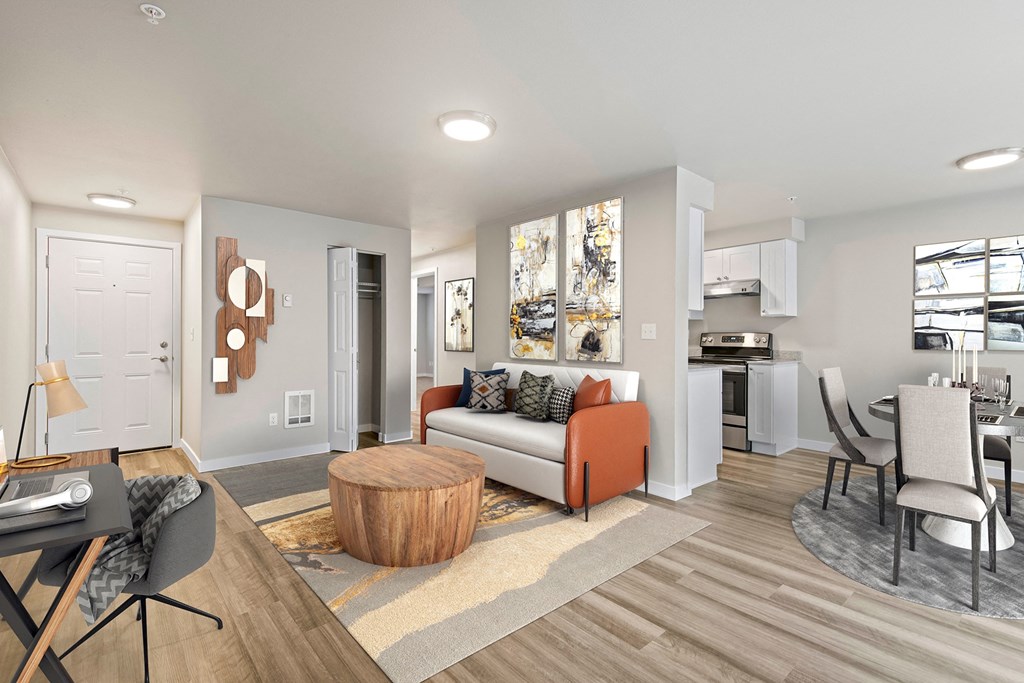 a living room with hardwood floors and view into dining room and kitchen at Foster Creek apartments in Tukwila