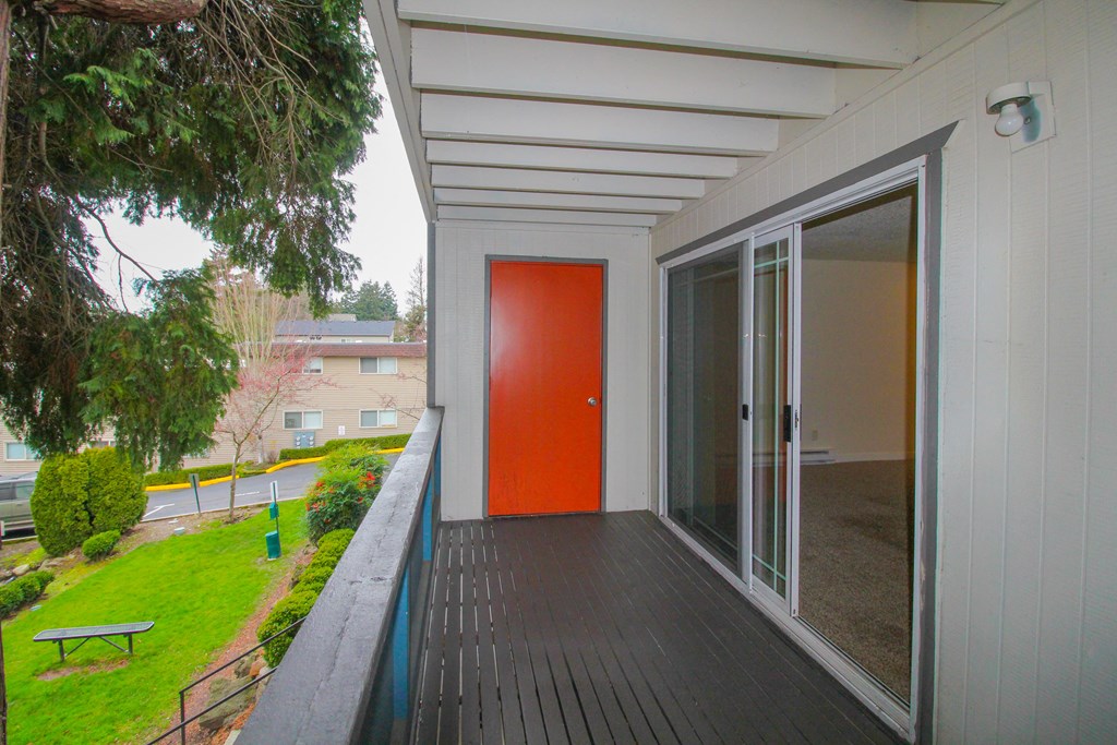 Tukwila, WA Apartments for Rent - Foster Creek - Private Balcony with Storage Closet Overlooking the Community with Lush Grass and Trees