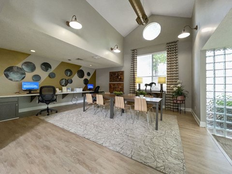 a large living room with a table and chairs and a window