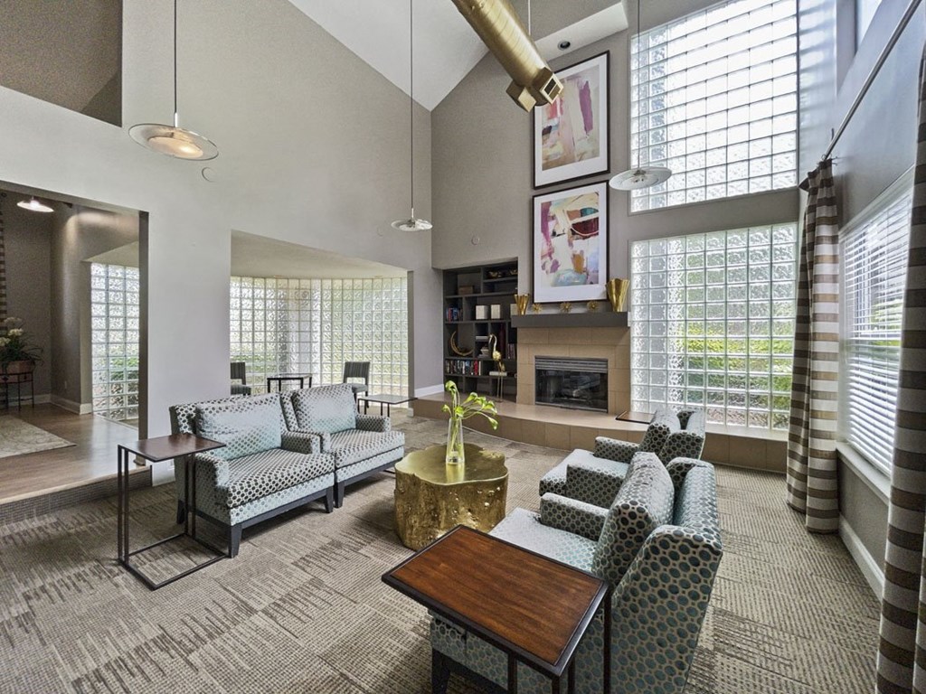 a living room with couches and chairs and a fireplace