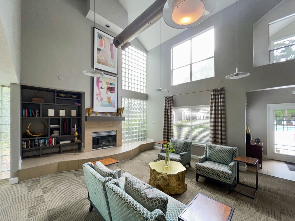 a living room with couches and chairs and a fireplace