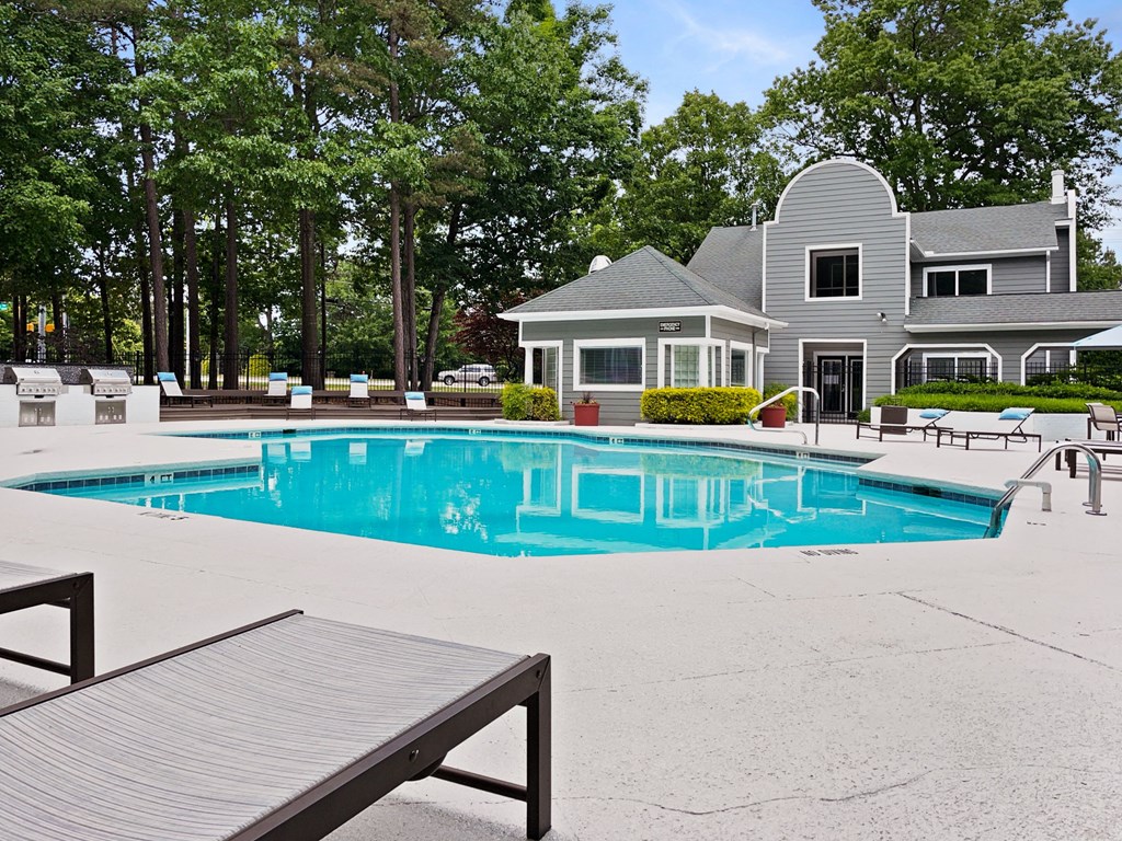 a swimming pool with a house in the background