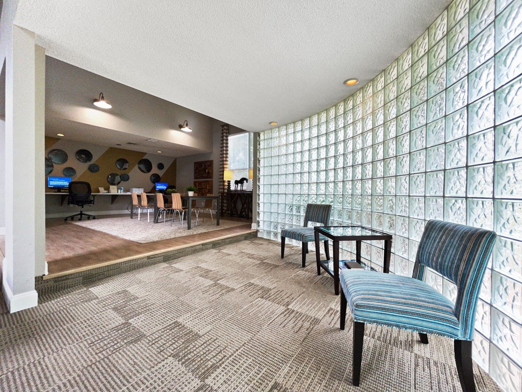 a room with chairs and a table and a lobby