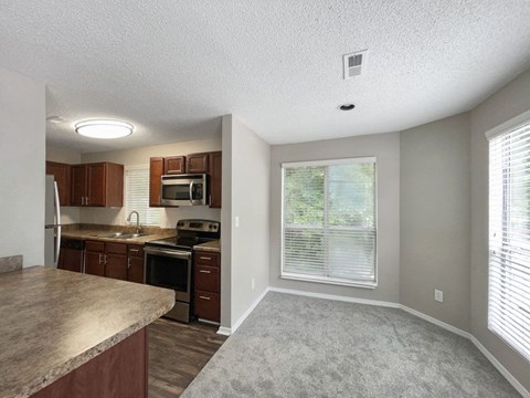 A kitchen with brown cabinets and a countertop.