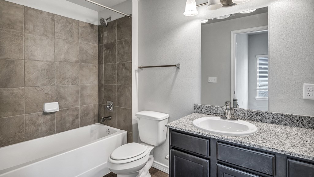 a bathroom with a sink toilet and a tub