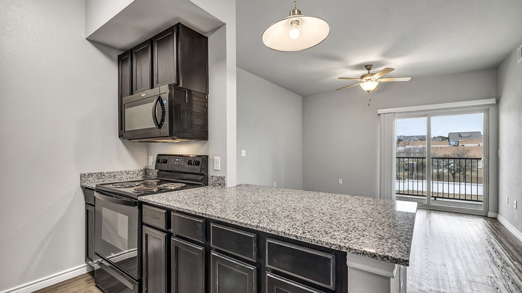 the kitchen of a home with a granite counter top