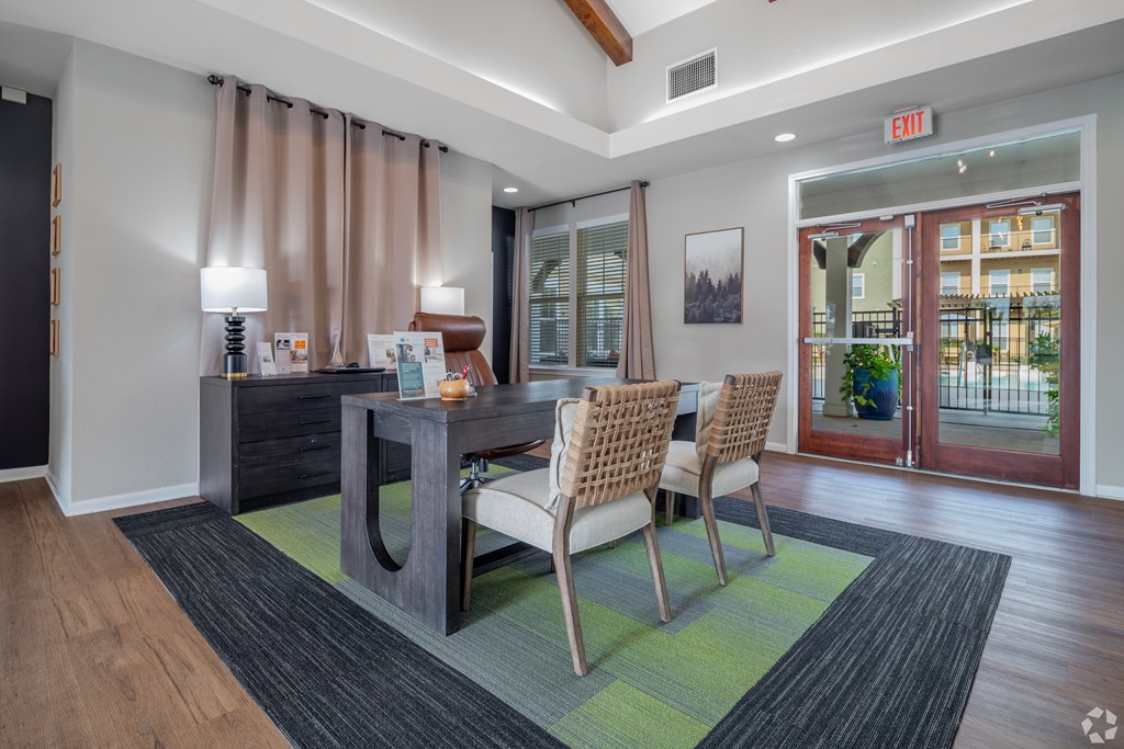 A dining room with a table and chairs.