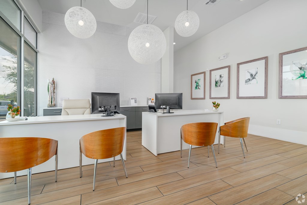 A white reception desk with a white counter and a white chair.
