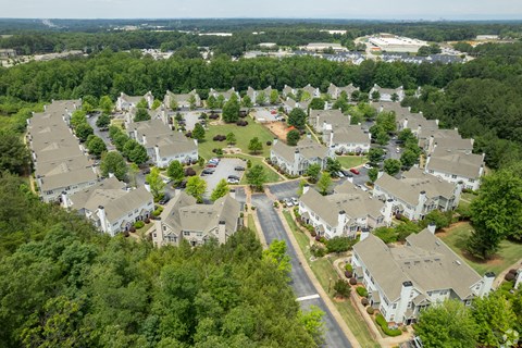 A bird's eye view of a residential neighborhood with houses and trees.