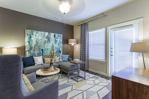 Model Living Room with Ceiling Fan and Patio/Balcony Entry