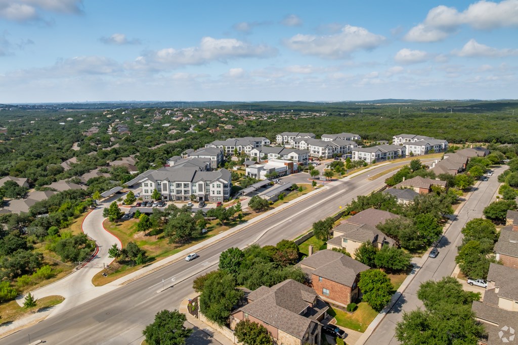 A bird's eye view of a residential area with houses and a road.