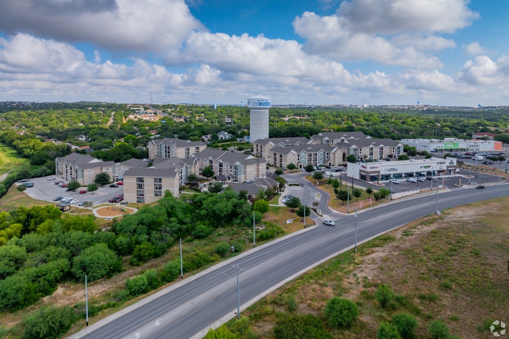 A view of a roundabout with a water tower in the background.