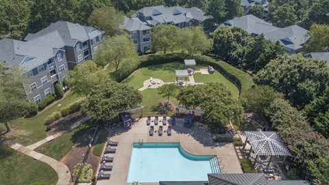 an aerial view of an apartment complex with a pool