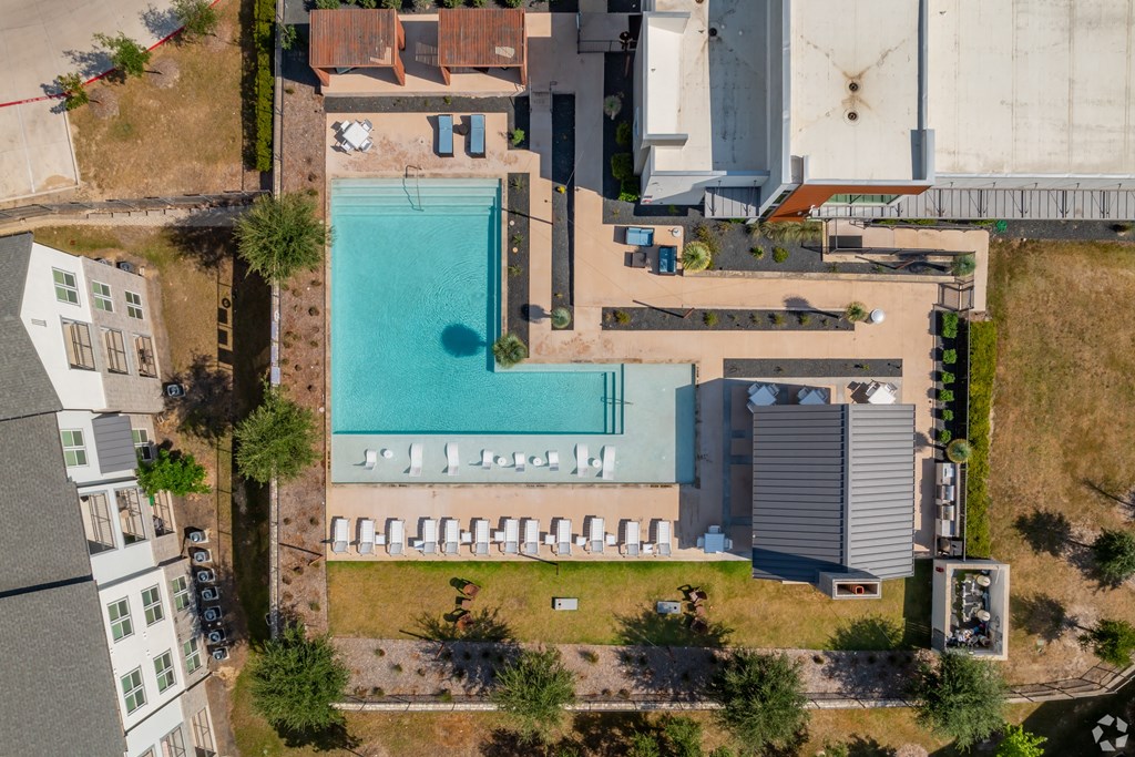 An aerial view of a swimming pool surrounded by buildings.