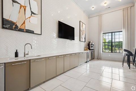 A modern kitchen with a white tile floor and a large window.